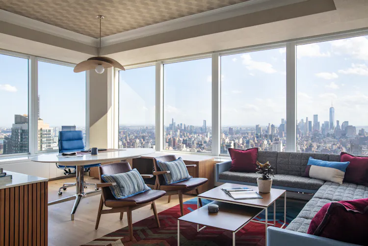 Luxury executive office at One Penn Plaza designed by K.A. Murphy Interiors with custom furnishings, layered textures, and expansive New York City skyline views.