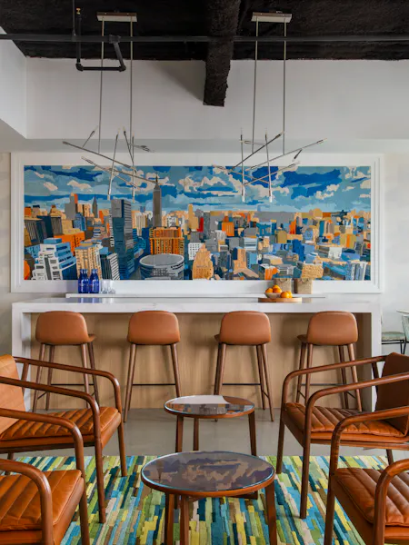 Luxury office interior at One Penn Plaza designed by K.A. Murphy Interiors with custom cityscape artwork, modern furnishings, and collaborative gathering spaces.