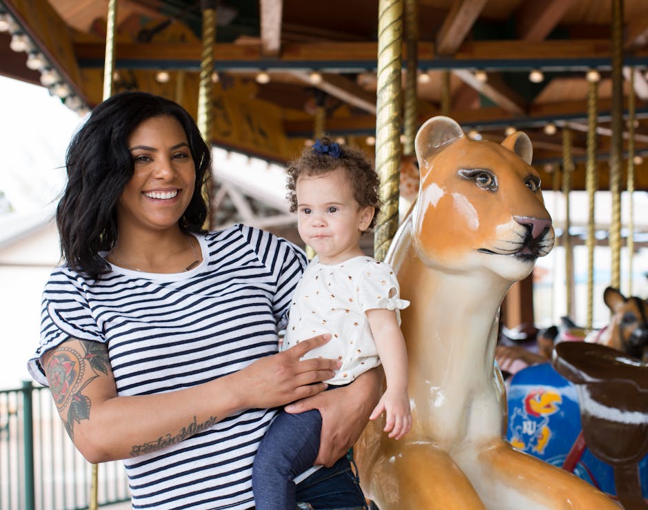 a mother and her child on a carousel 