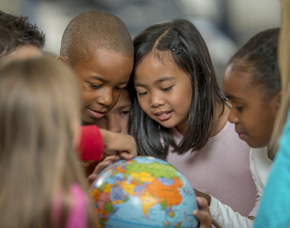 Kids looking at a globe