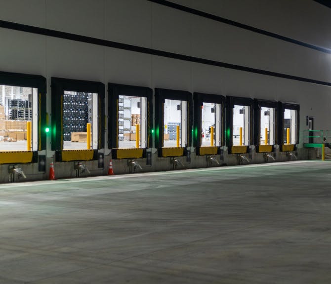 Open loading bays at a warehouse during nighttime