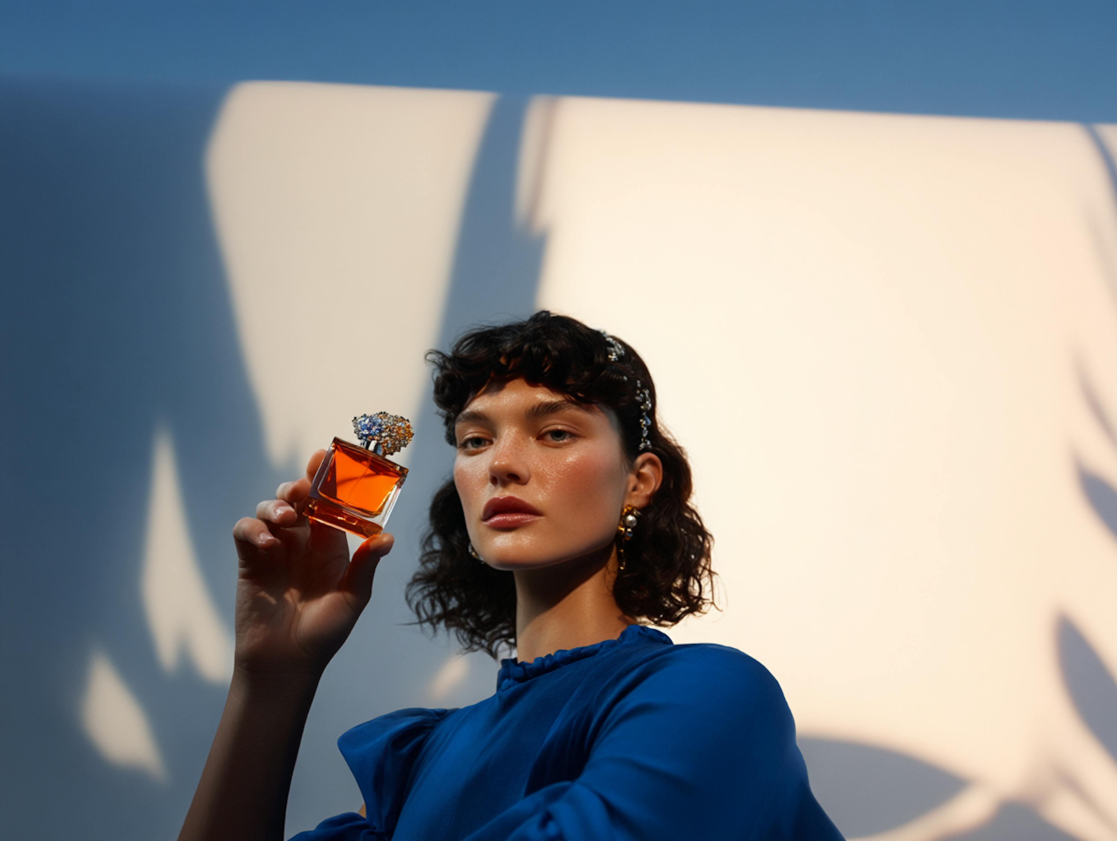 woman holding fragrance
