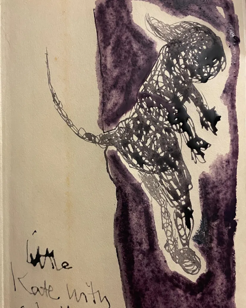 Little Kate with a tail. Tiny drawing ina book.