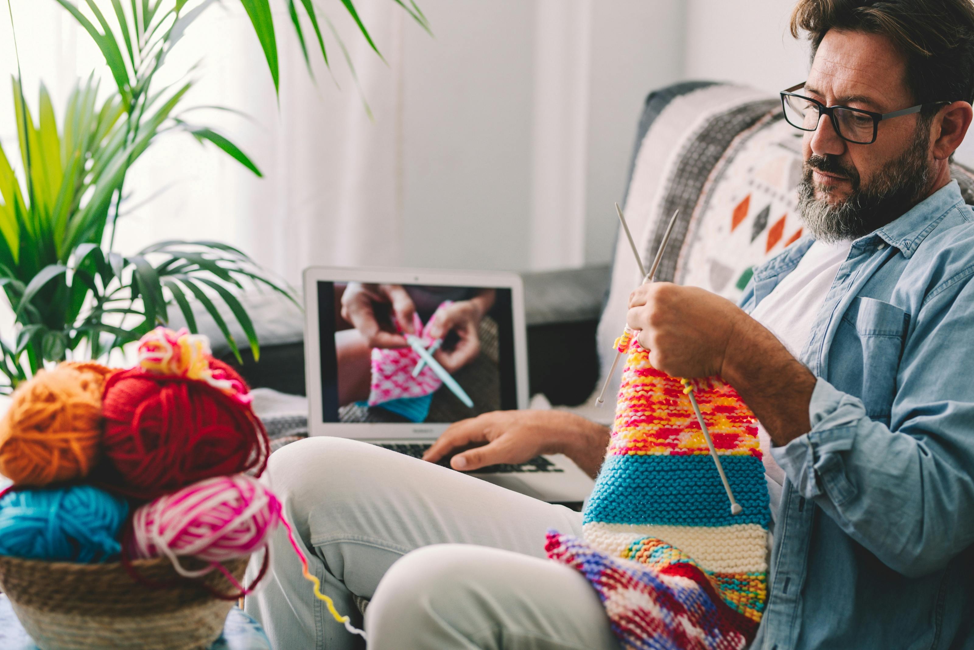 Photograph of a man knitting