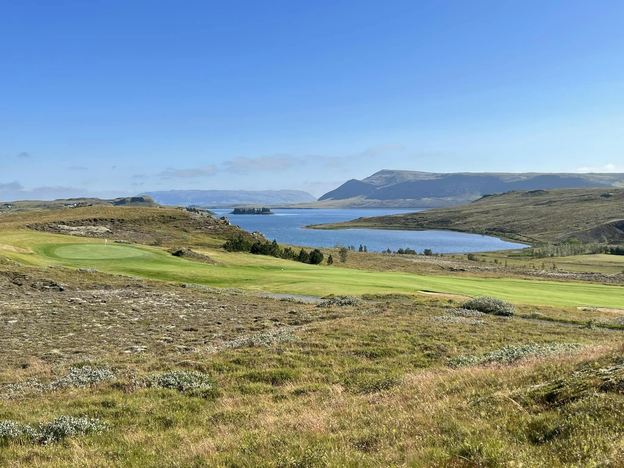 golf course with a river side view