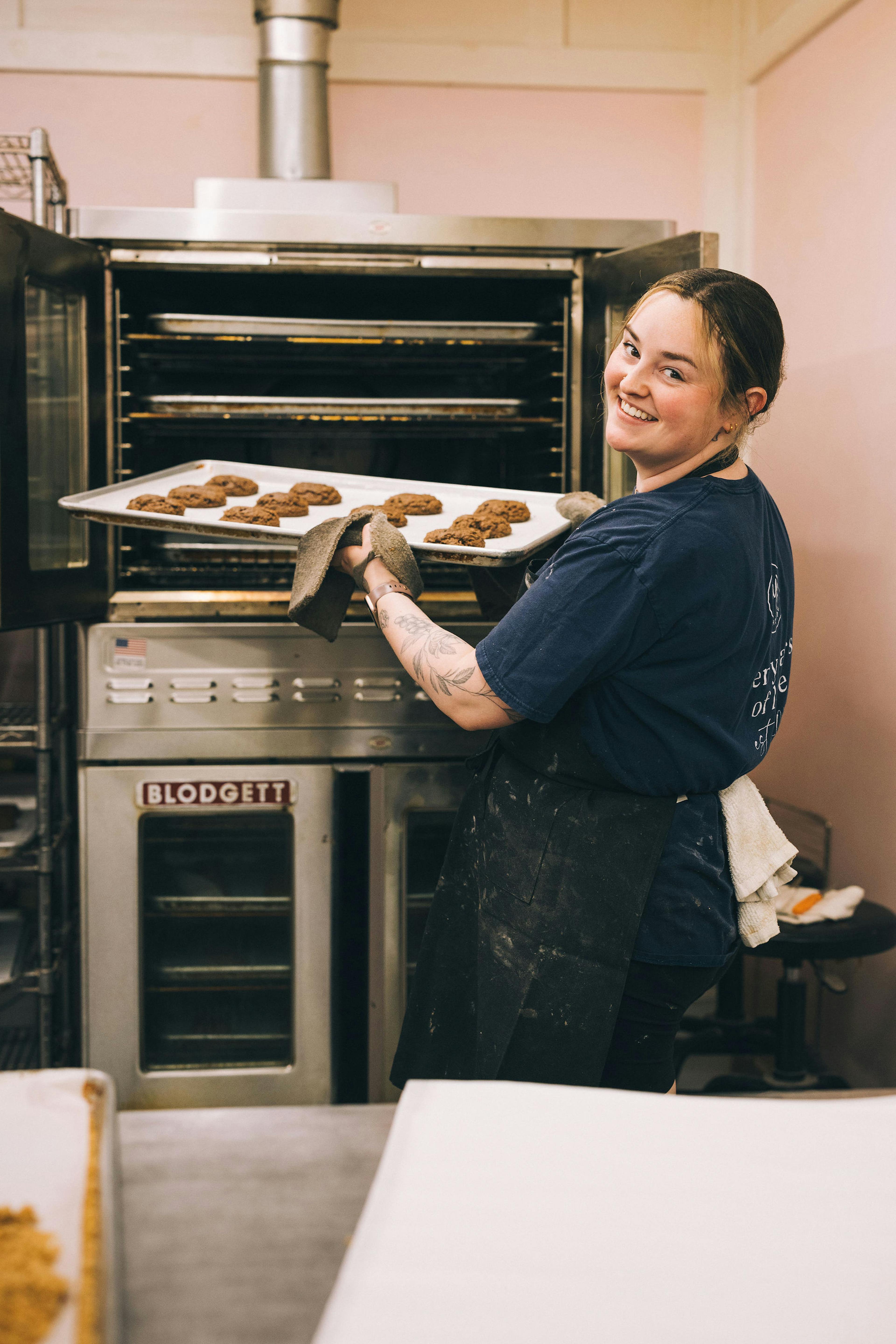 happy baker taking cookies out of the oven