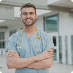 Health Sector. A young doctor smiles at the camera.