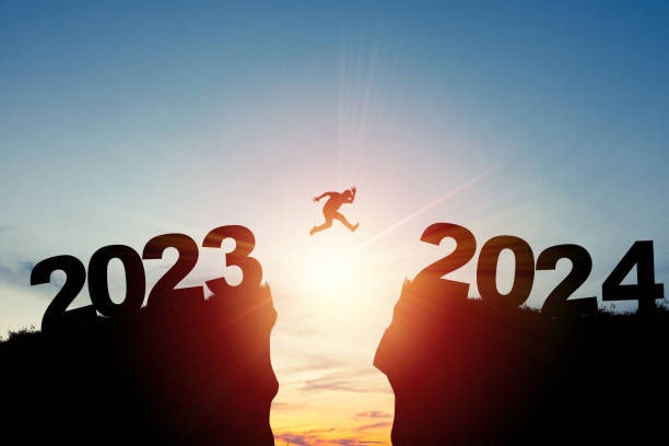 Man jumping between '2023' and '2024'