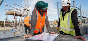 Two builders looking over plans