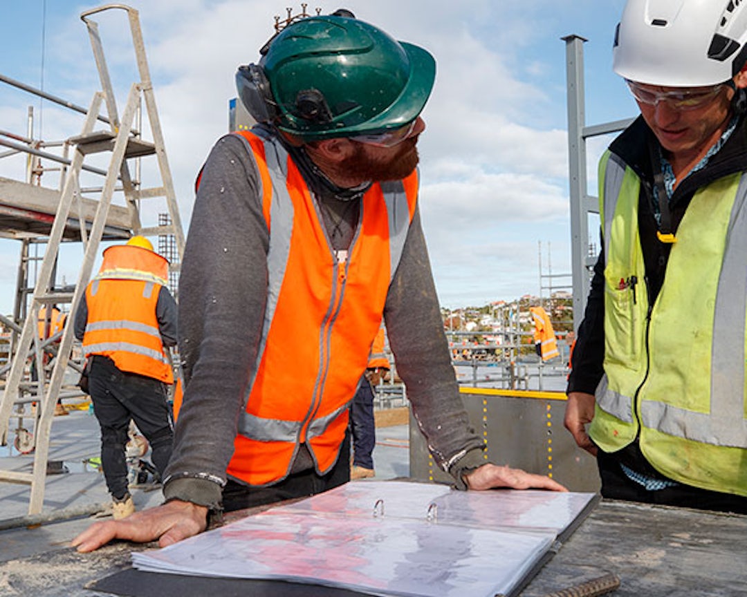 Two builders looking over plans