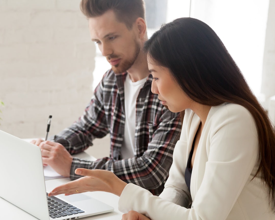Two people looking at a computer