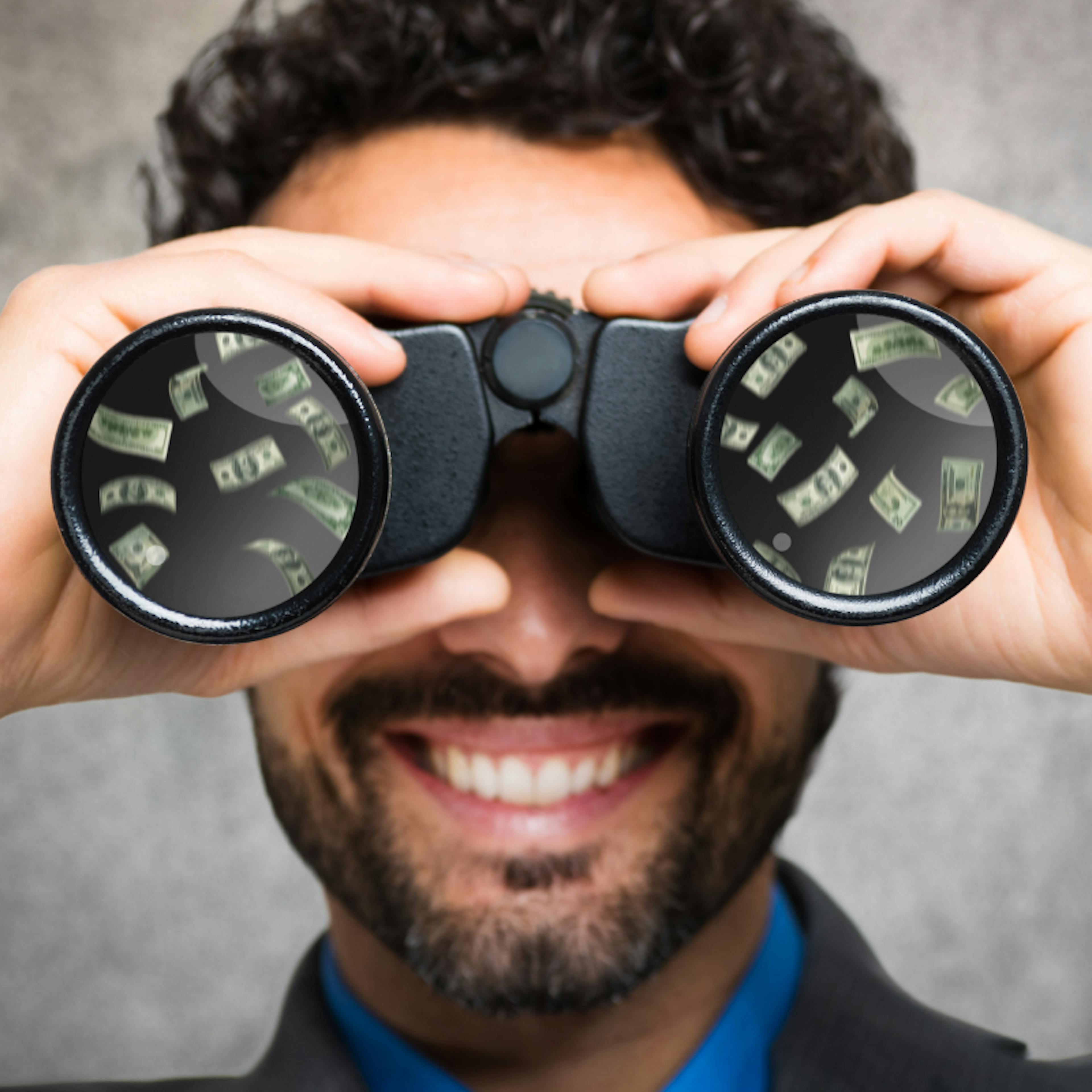 Man looking through binoculars