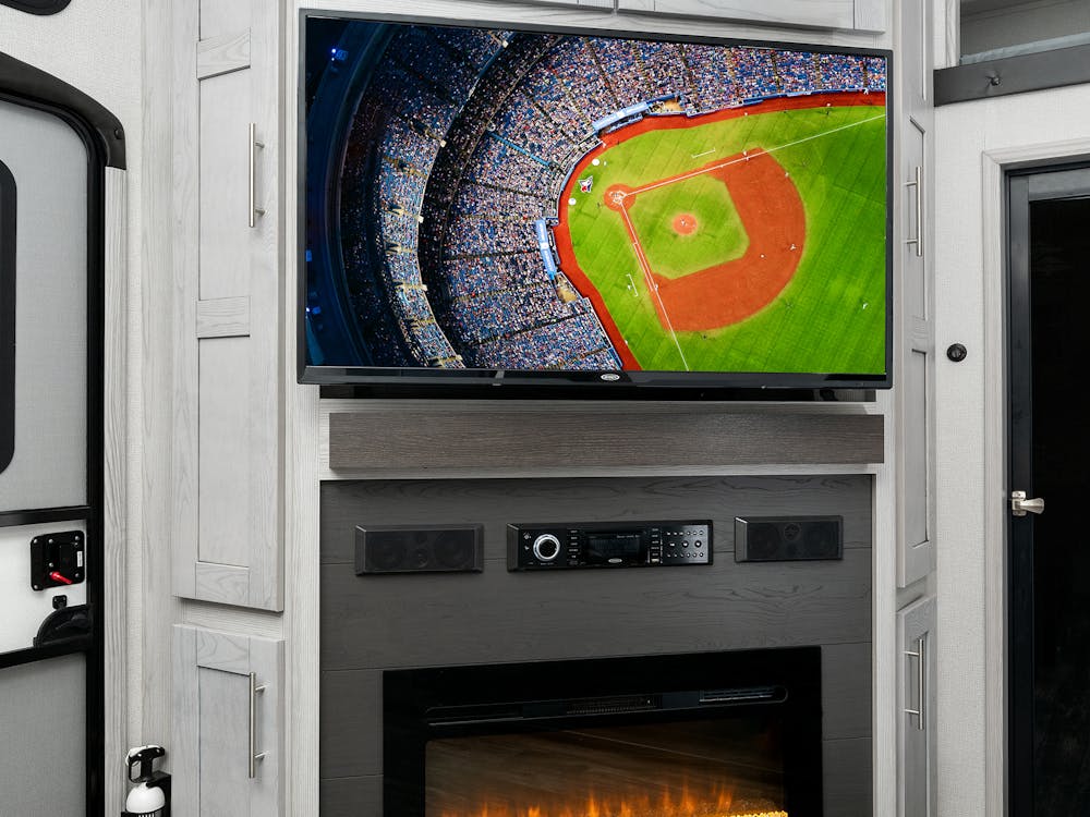 Keystone Fuzion 427 entertainment center, fireplace and TV shown in photo