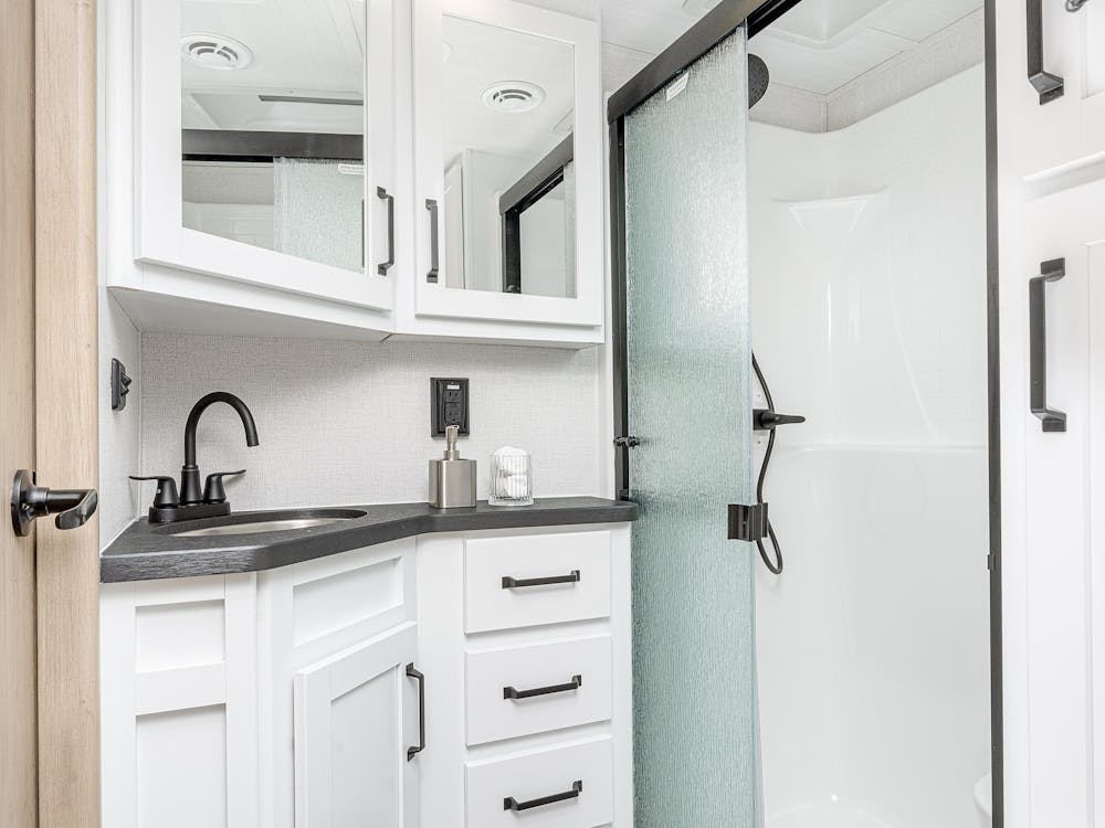 Raptor 424 main bathroom, showing off large vanity with tons of storage and shower
