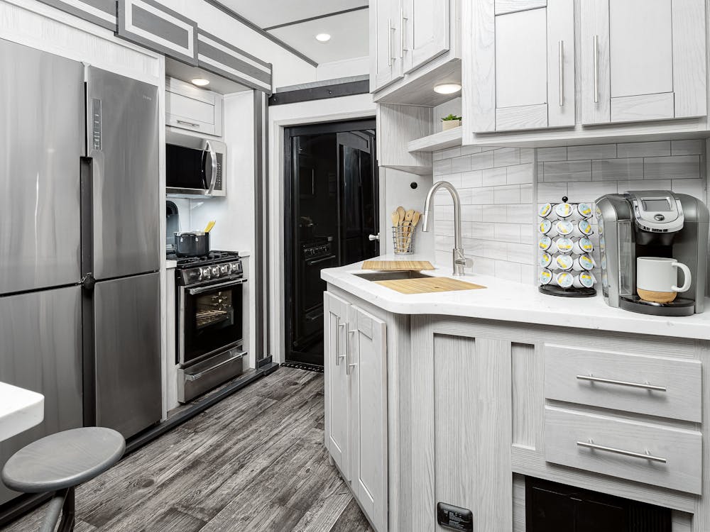 Keystone Fuzion 424 kitchen, wrap around counter and refrigerator shown in photo