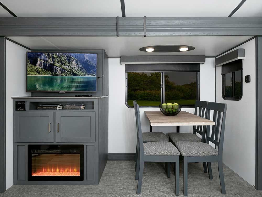 Entertainment slide in the 25RKPR, featured fireplace, TV, and Table & Chairs