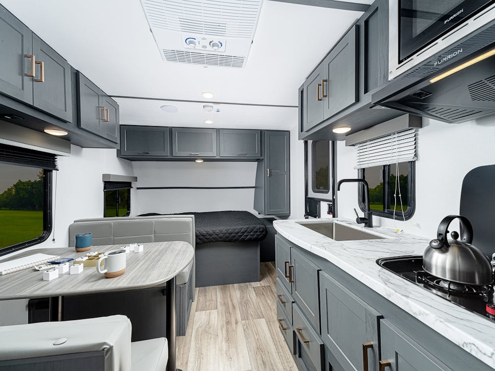 Bullet Crossfire 1700BH, showing off dinette, kitchen, and front bed