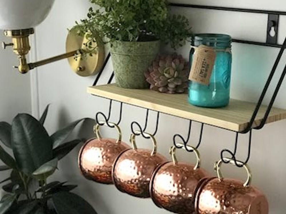 Hanging cups next to wall sconce