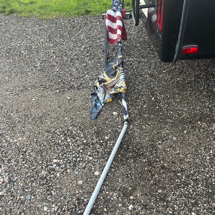 RV flag pole broken after high winds at campground.