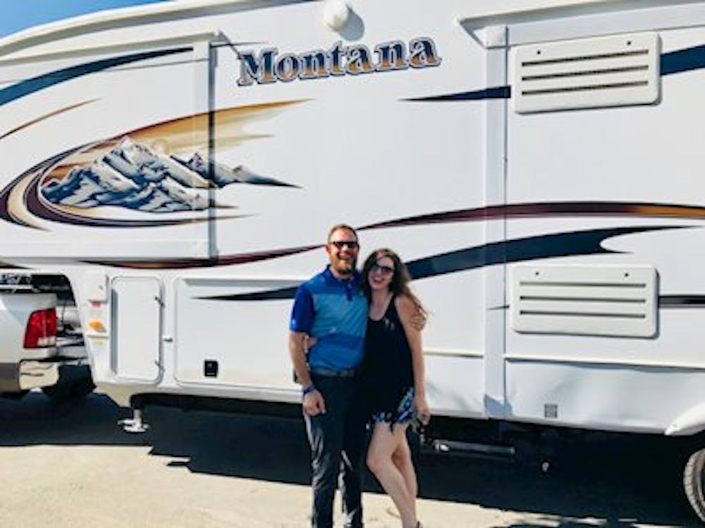 Couple standing in front of Montana Fifth Wheel