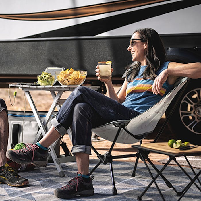 Couple relaxing outside of their Keystone Sprinter