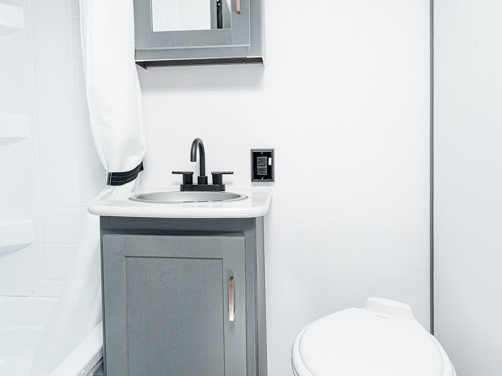 Bullet Crossfire 1700BH bathroom, showing toilet, vanity, & shower