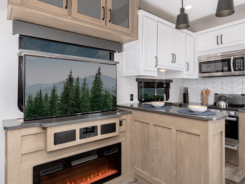Raptor 424 entertainment center with side view of kitchen, showing TV and fireplace