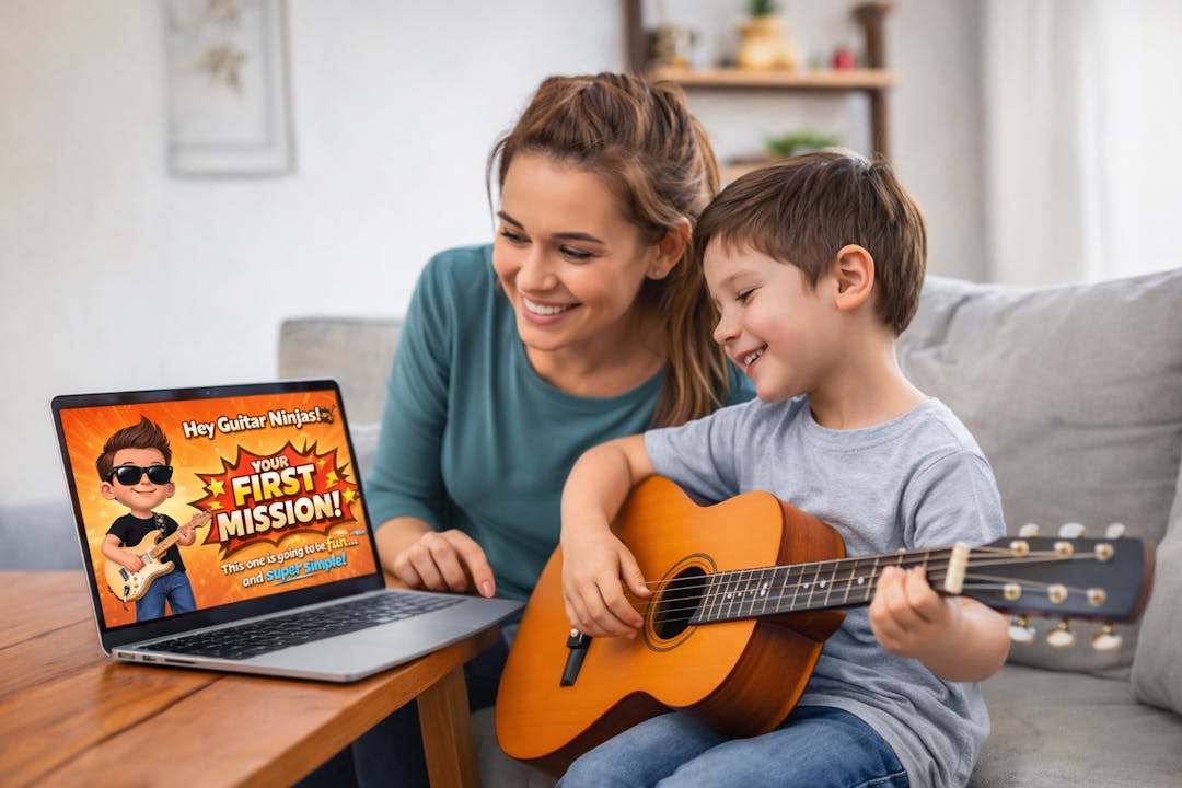 Mother and son learning guitar at home using a Kids Guitar Dojo online lesson on a laptop