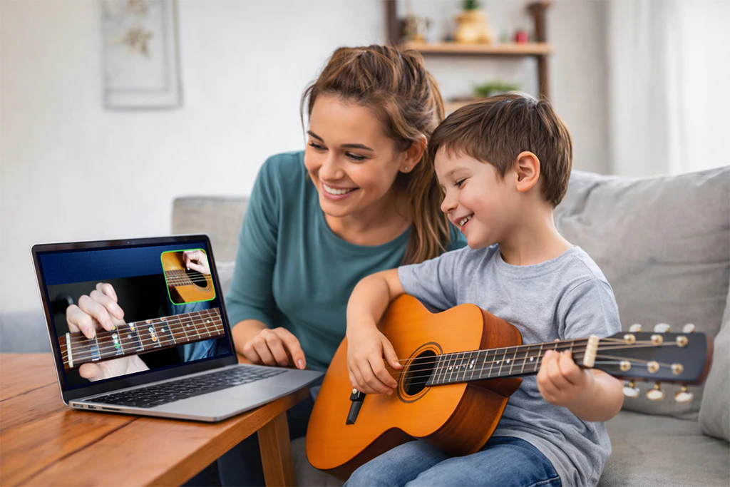 Parent helping child learn guitar while watching an online guitar lesson on a laptop