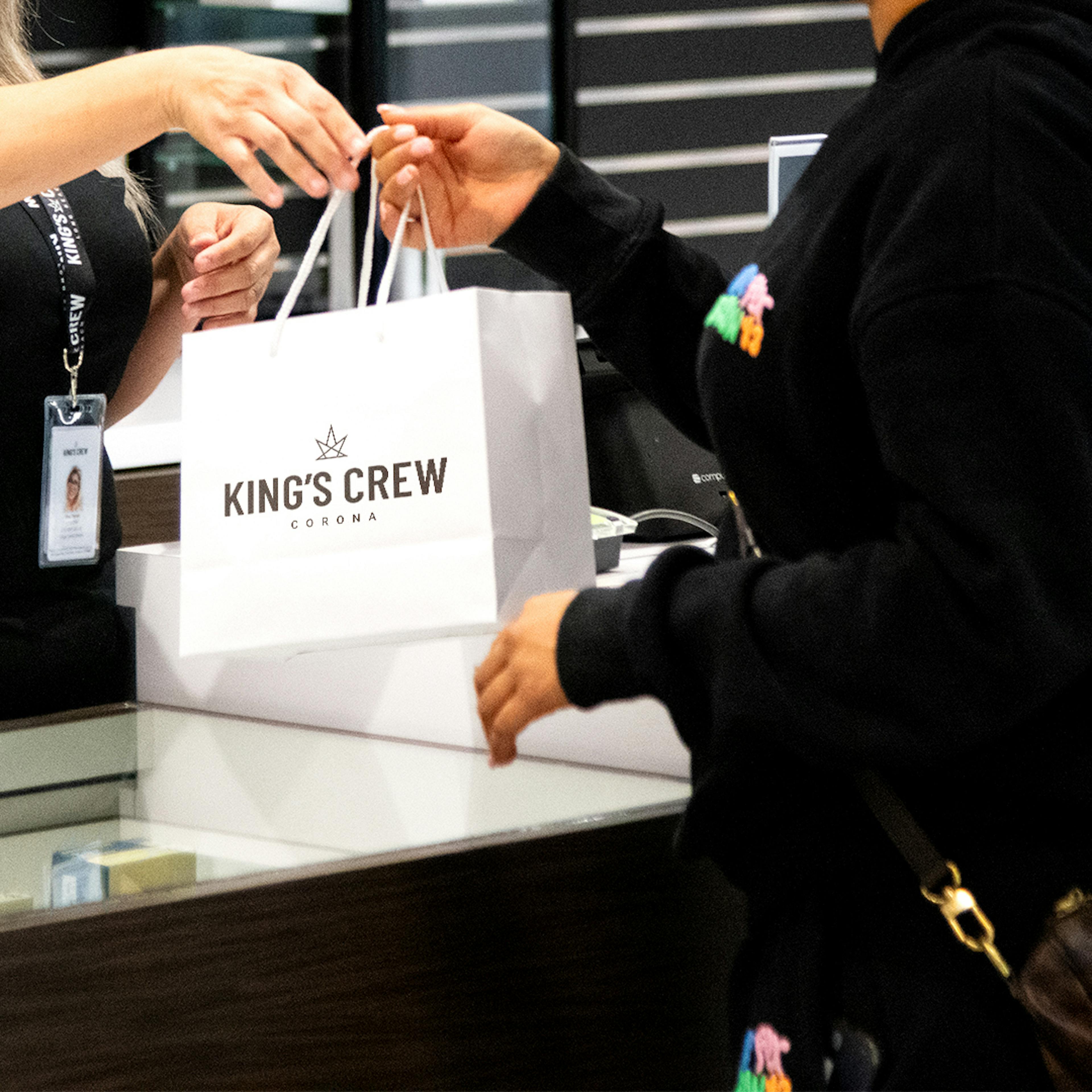 Crew Member handing a bag to a customer