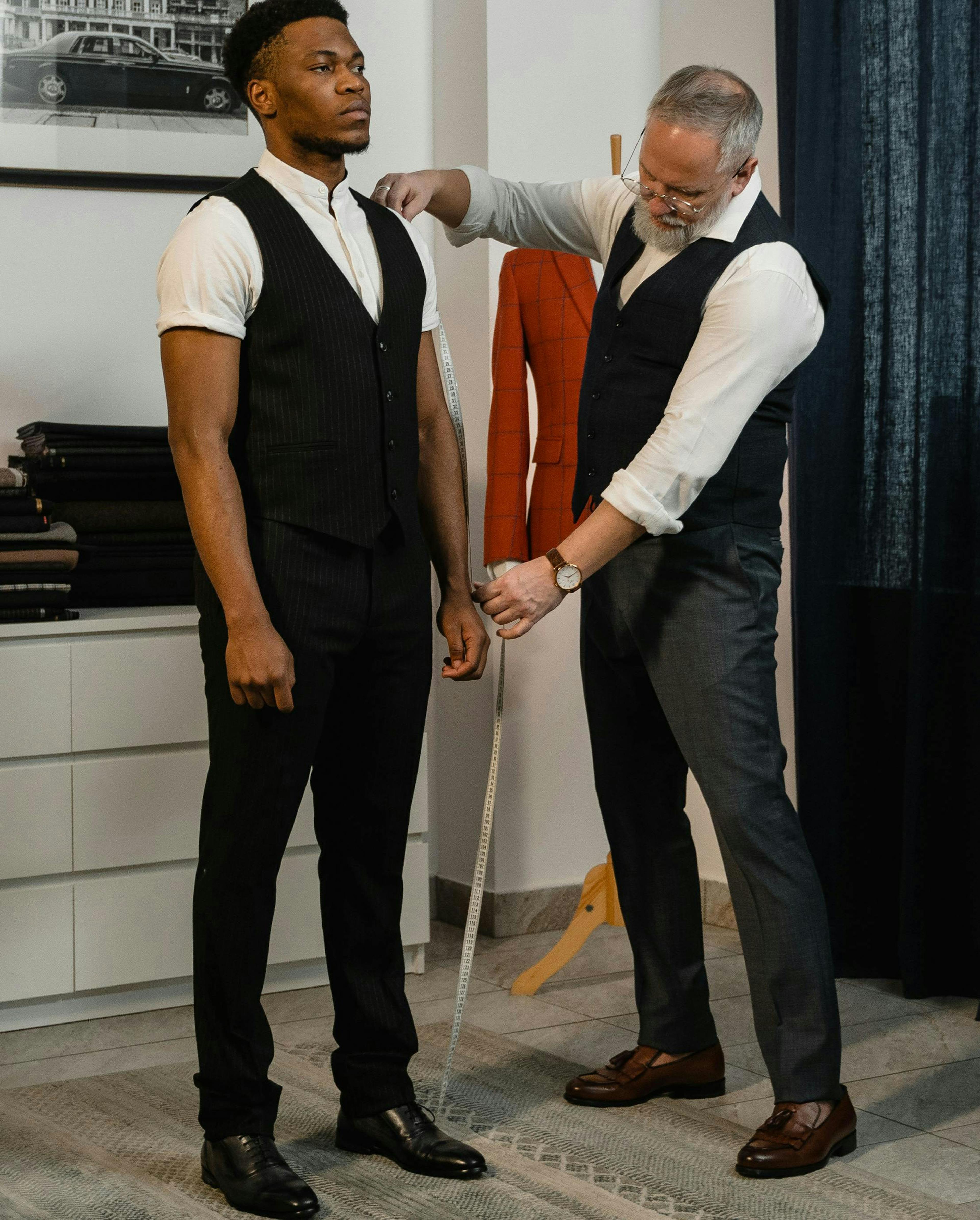 A Tailor Measuring a Man's Sleeves