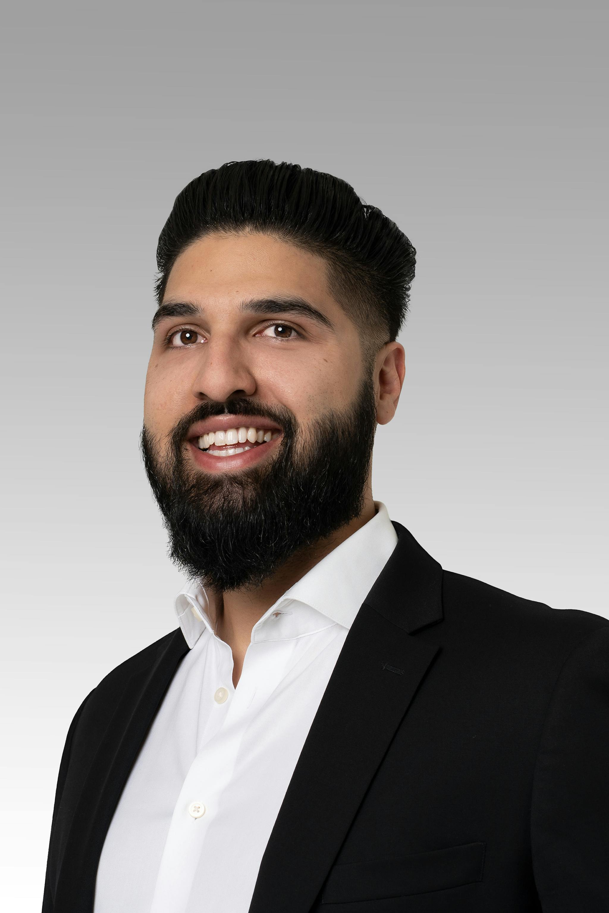 Jasdeep Gill headshot on a gray gradient backdrop