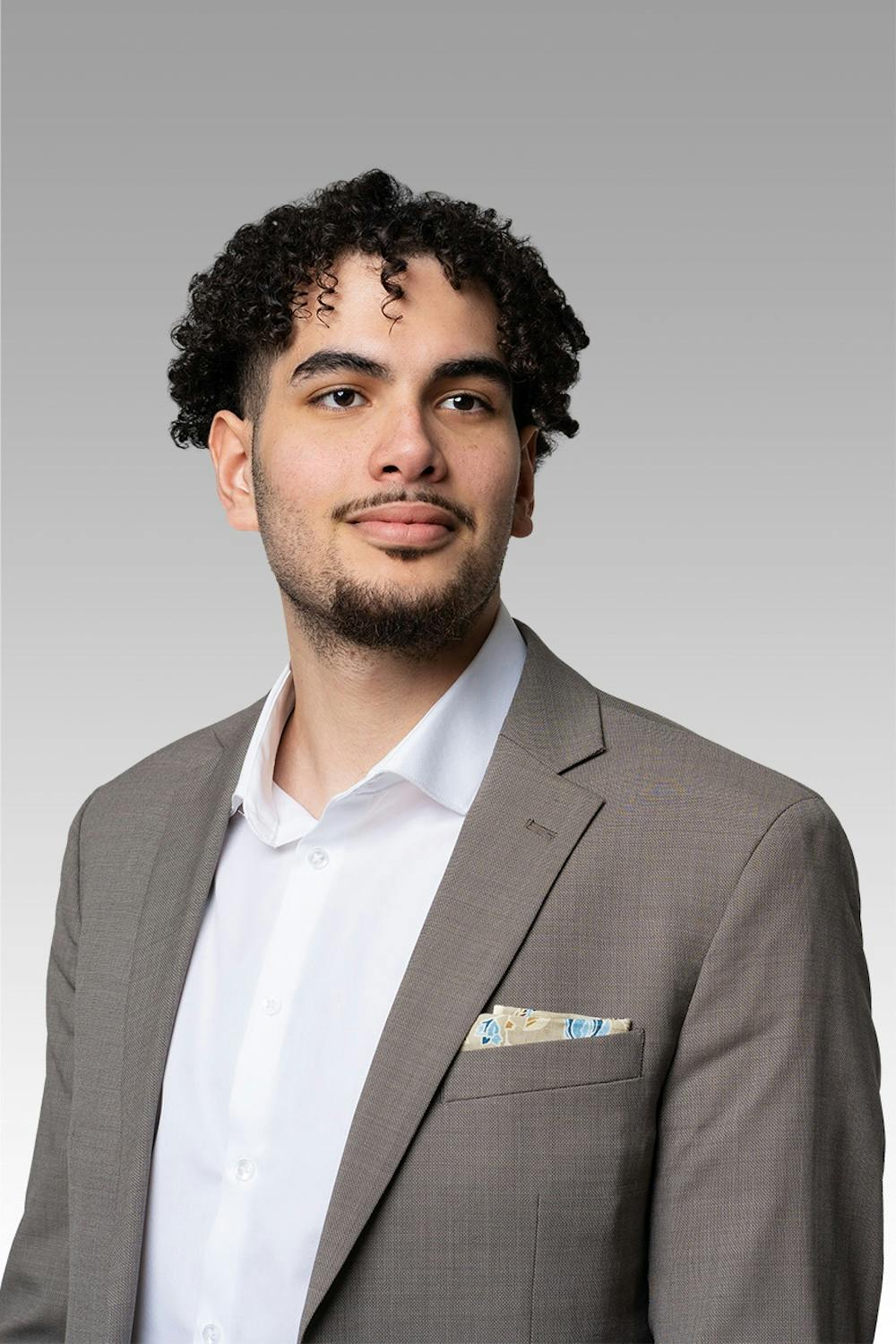 Motaz Bakr headshot on a gray gradient backdrop