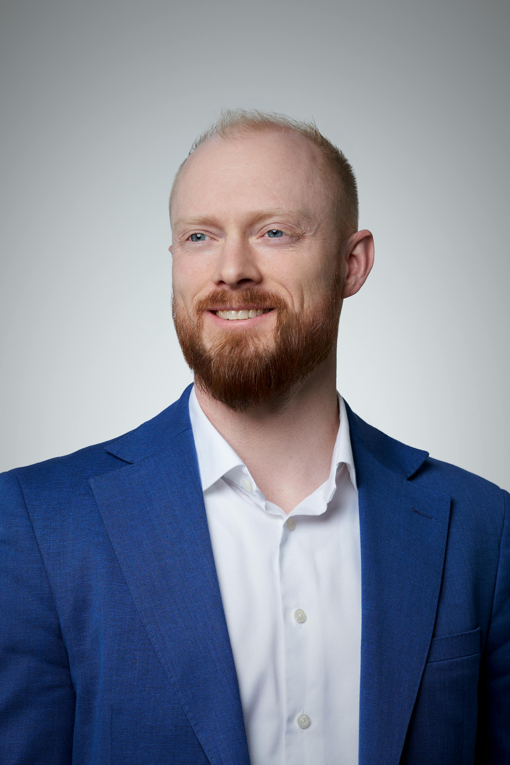 Adam Payne headshot on a gray gradient backdrop