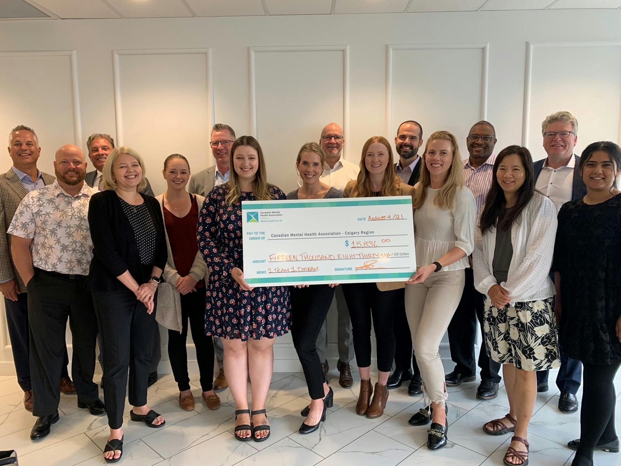 Kinsted providing Canadian Mental Health Association with a cheque for $15,836.00