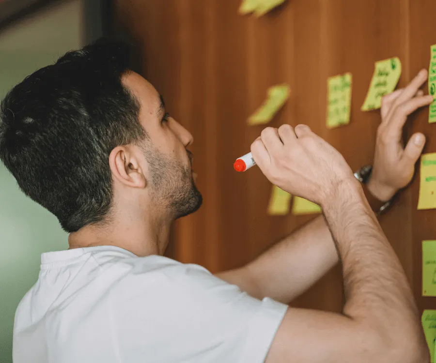 A man brainstorming ideas for classic Seahawks custom football shirts in a wooden board - Kittl