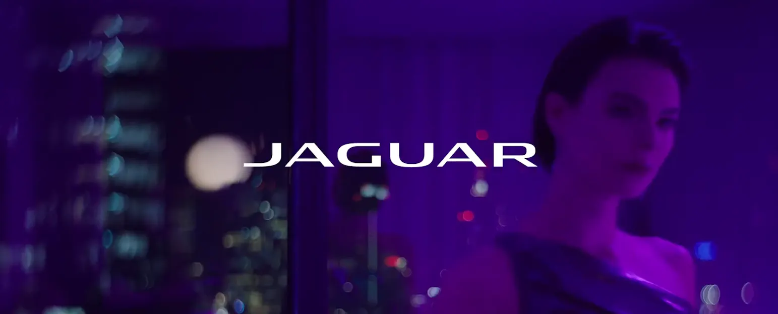 Jaguar's marketing on its website where the branding are dominated with neon and monochromatic colors - Kittl