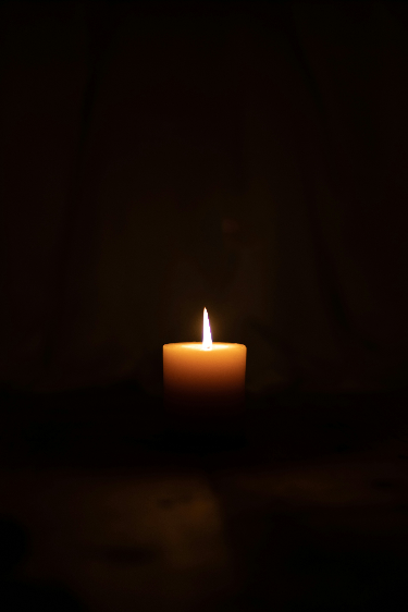 Free Good Friday photo of a dark mood photography with a single candle - Kittl
