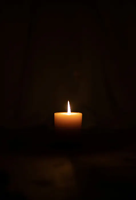 Free Good Friday photo of a dark mood photography with a single candle - Kittl