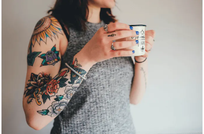 A woman with American Traditional Style Tattoos on her arm
