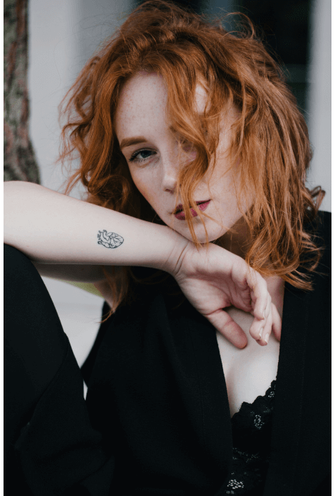 A woman with a minimalist style tattoo