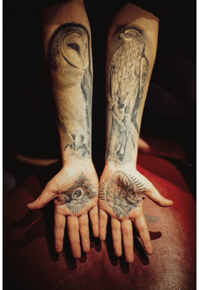 Two arms with realism style tattoos of animals