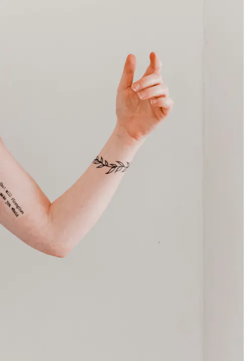 Line Art Style Tattoos on woman's arm