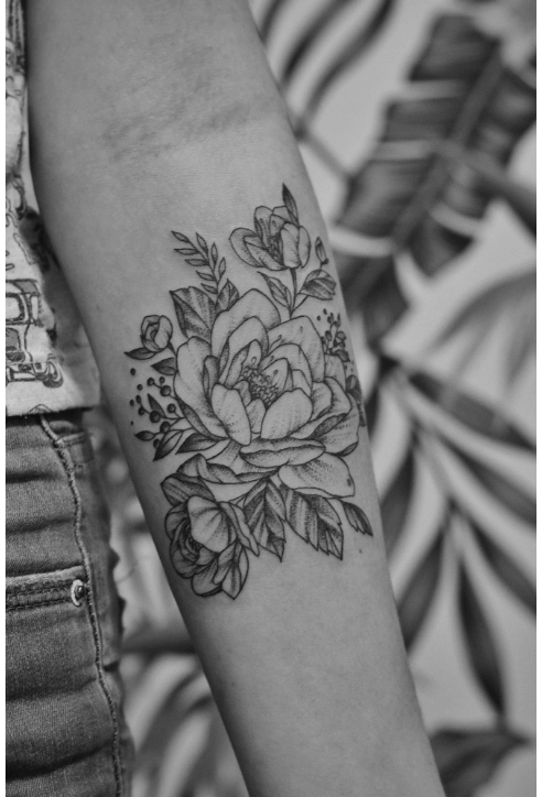 Fine line style tattoo of flowers