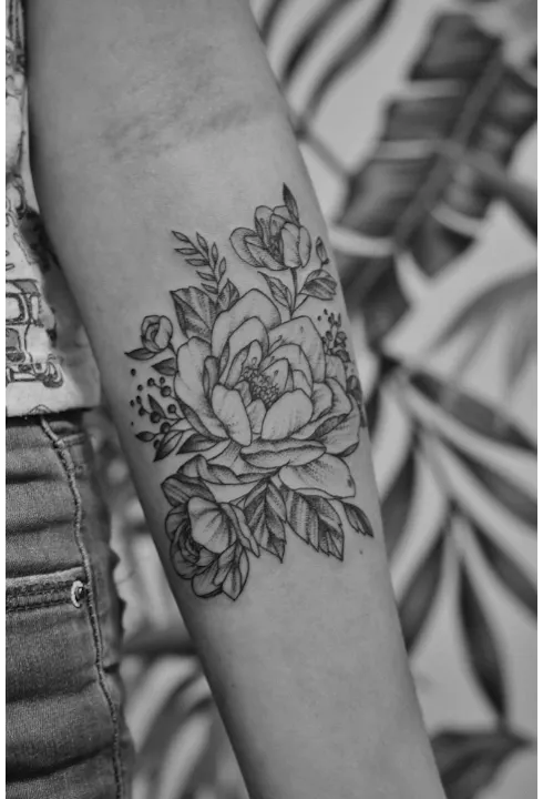 Fine line style tattoo of flowers
