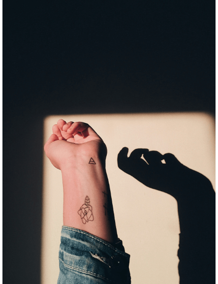 An arm with a stick and poke tattoo