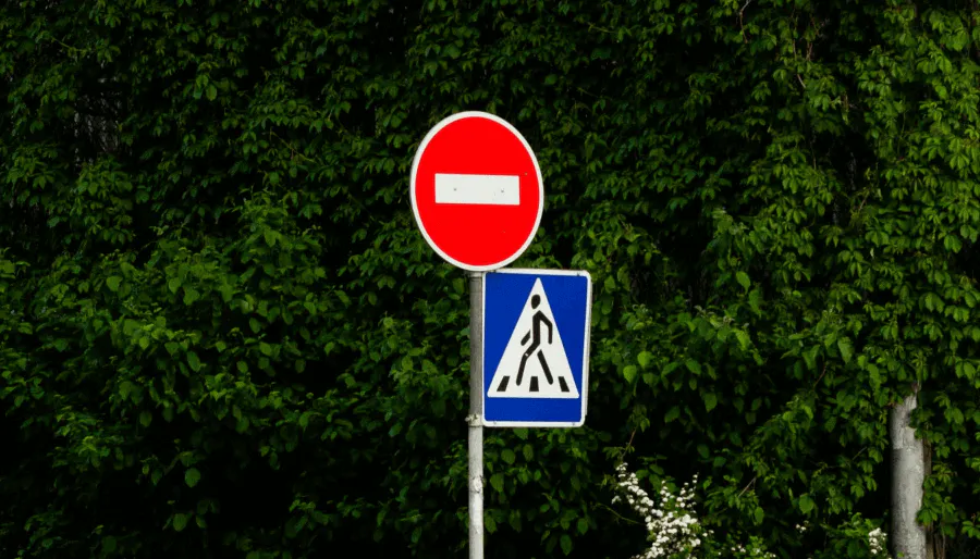 Color contrast in street sign like stop and cross helps people read the signs & makes a design clearer for everyone - Kittl