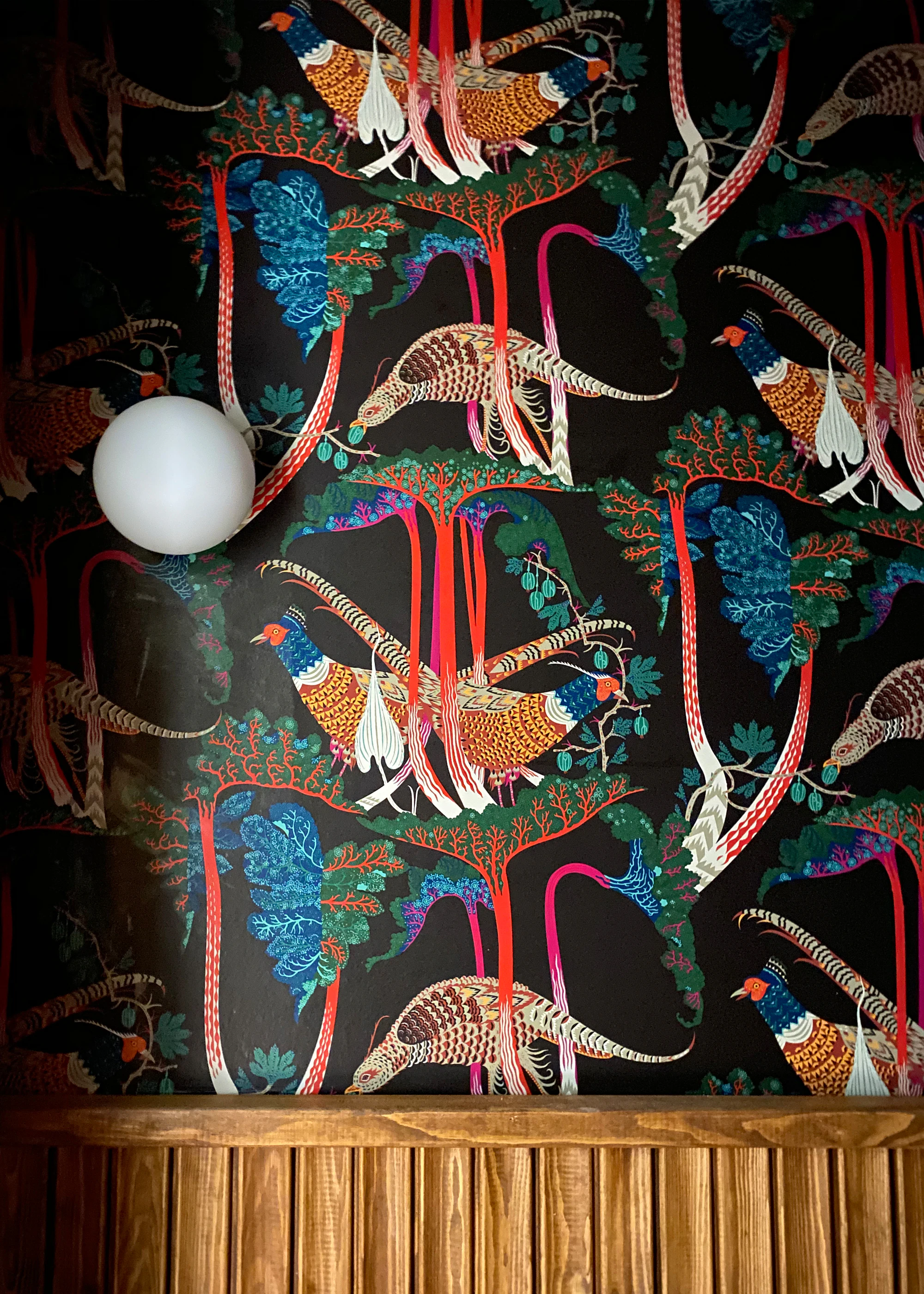 Klaus Haapaniemi wallpaper with pheasants in red, blue and gold on a black ground
