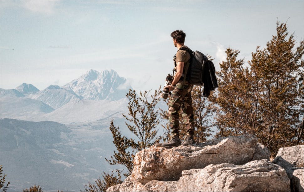 backpacker standing on a cliff