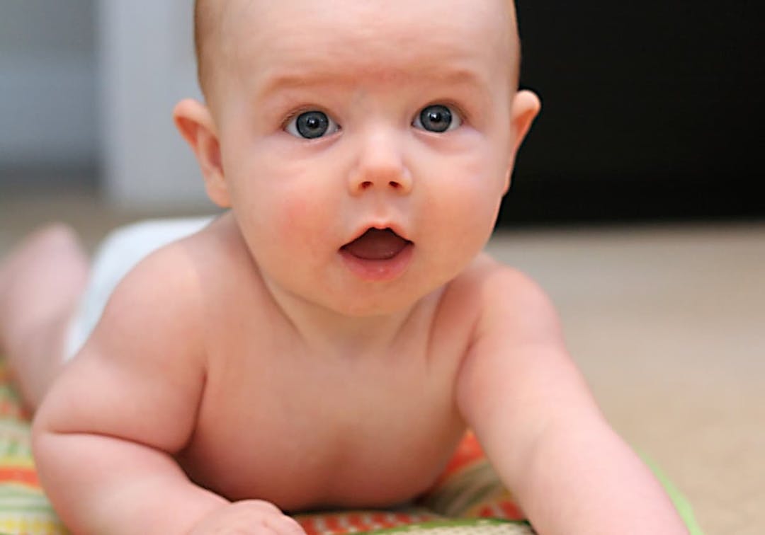 bebis ligger på mage